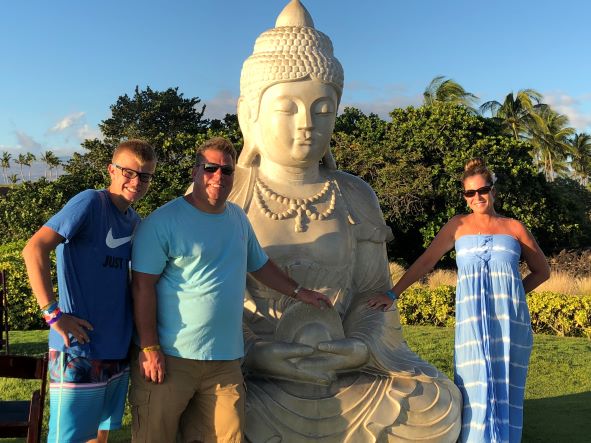 Hilton Grand Vacations Owners posing for family picture at Buddha Point, Ocean Tower, a Hilton Grand Vacations Club, Big Island, Hawaii.