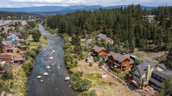 Aerial image, historic houses lining mountain river, Truckee, California.